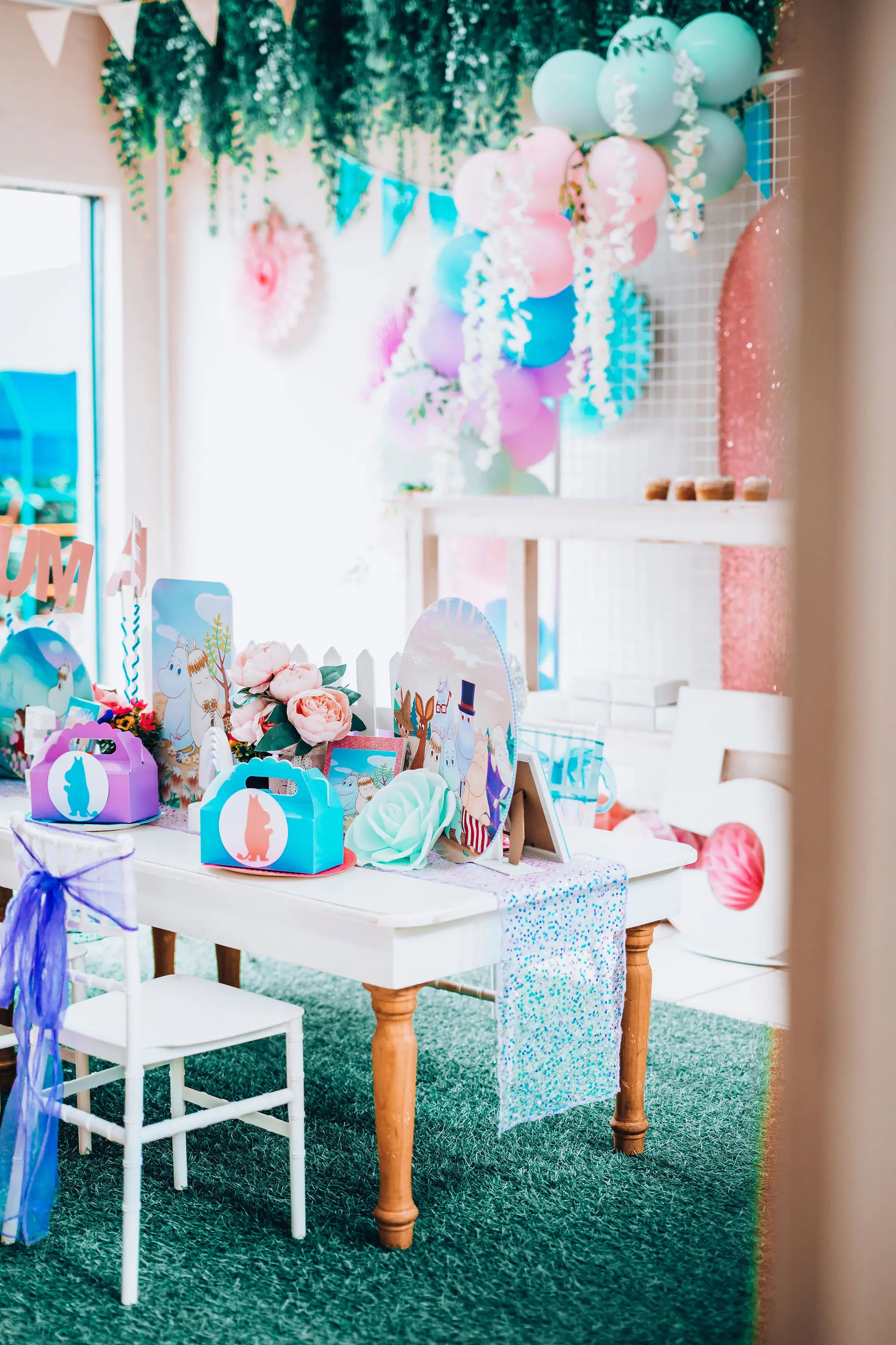 A pastel rainbow party table, set and waiting