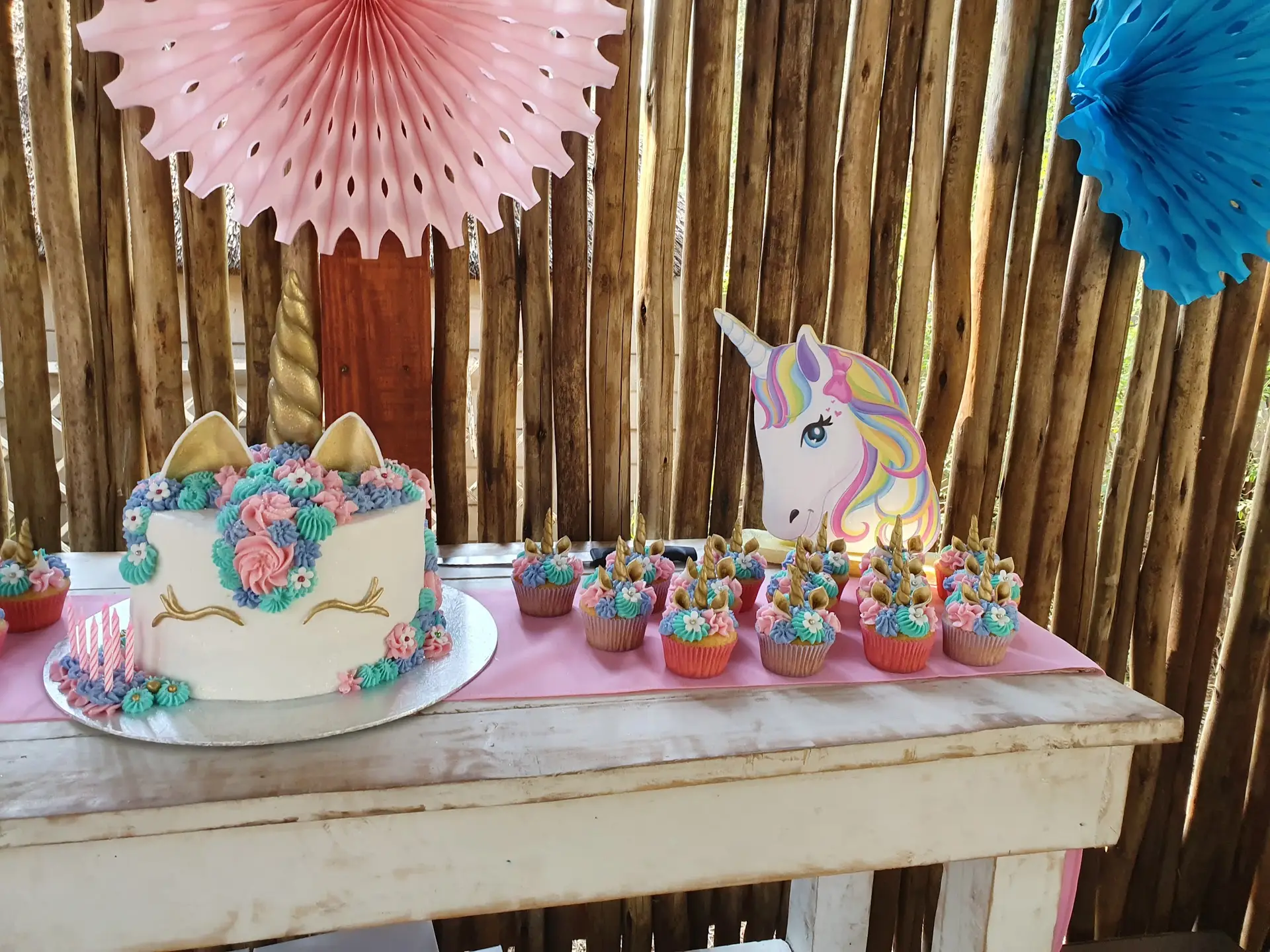 A unicorn cake against the bamboo screen