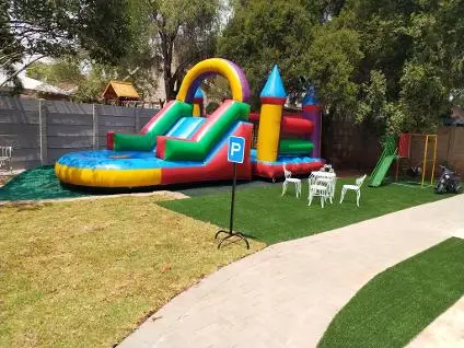 The jumping castle and slide on the lawn